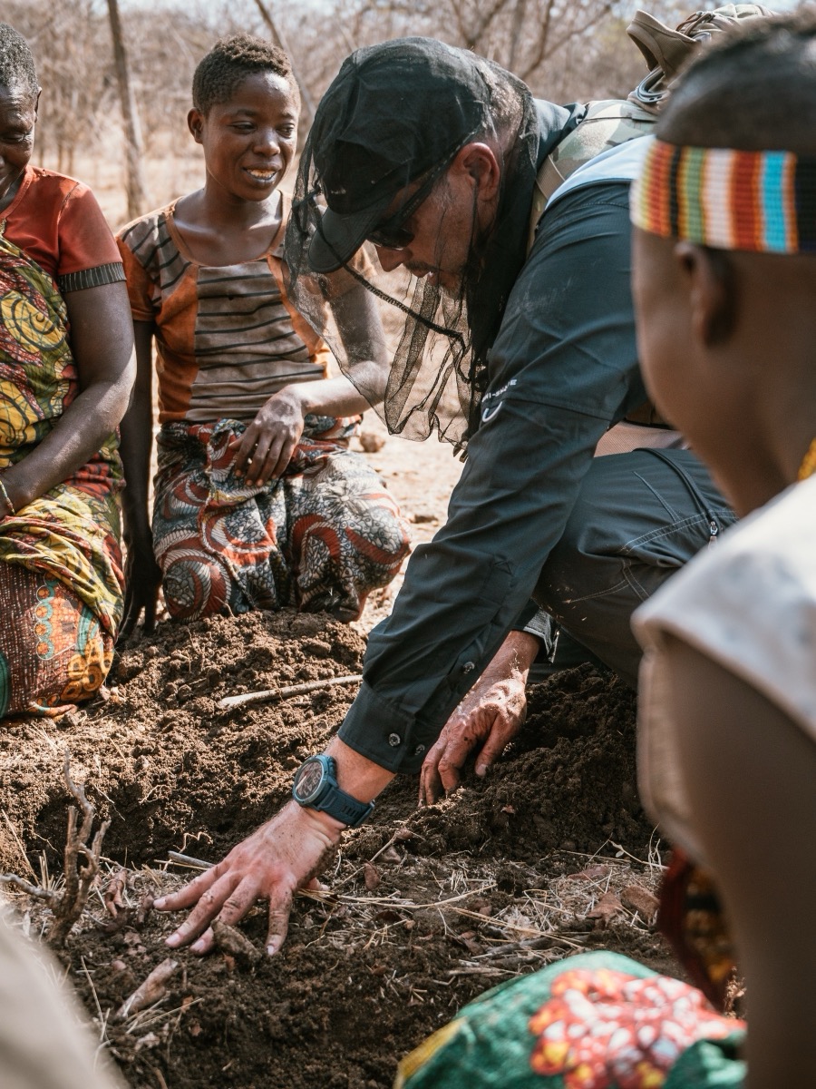 Guests taking part in digging tubers with the Hadza