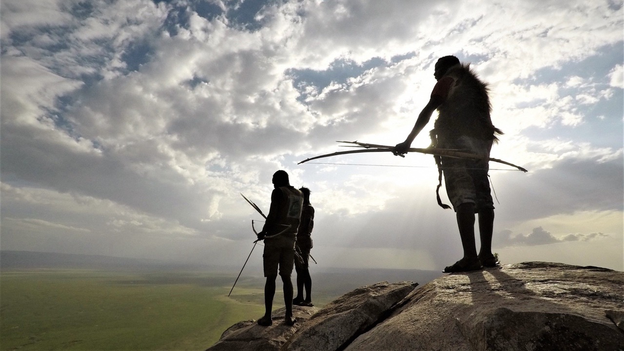 Hadza hunters silhouetted against the sunset